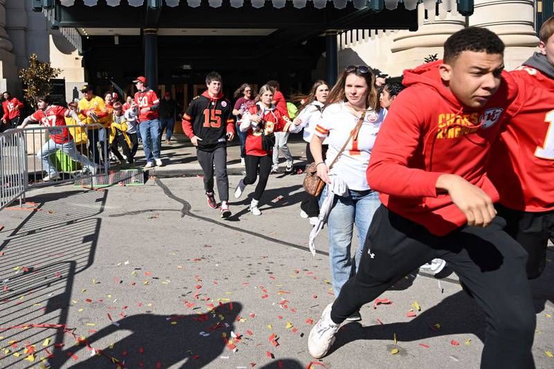 People flee after shots were fired near the Kansas City Chiefs' Super Bowl LVIII victory parade on February 14, 2024, in Kansas City, Missouri. A shooting incident at a packed parade Wednesday to celebrate the Kansas City Chiefs' Super Bowl victory killed one person and injured nine others, the city fire department said. (Photo by ANDREW CABALLERO-REYNOLDS / AFP) (Photo by ANDREW CABALLERO-REYNOLDS/AFP via Getty Images)