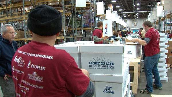 Light of Life volunteers boxing up thousands of Thanksgiving meals for families in need
