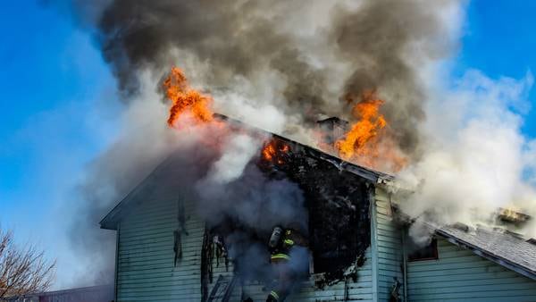 PHOTOS: Fire burns hole through roof of house in Unity Township