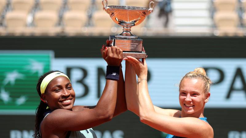 PARIS, FRANCE - JUNE 09: Coco Gauff of United States and Katerina Siniakova of Czechia celebrate with the trophy after victory against Jasmine Paolini of Italy and Sara Errani of Italy in the Women's Doubles Final match on Day 15 of the 2024 French Open at Roland Garros on June 09, 2024 in Paris, France. (Photo by Dan Istitene/Getty Images)