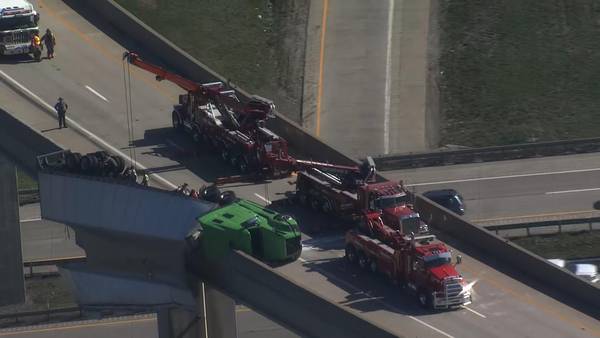 Driver facing citation after tractor-trailer overturns, hangs from overpass in Washington County
