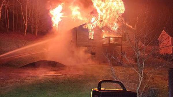 PHOTOS: Woman injured after jumping from roof of burning home in Washington County