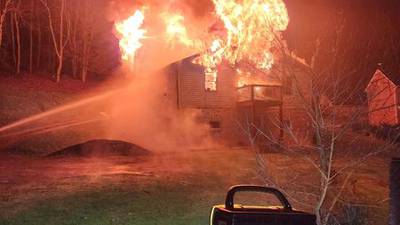 PHOTOS: Woman injured after jumping from roof of burning home in Washington County