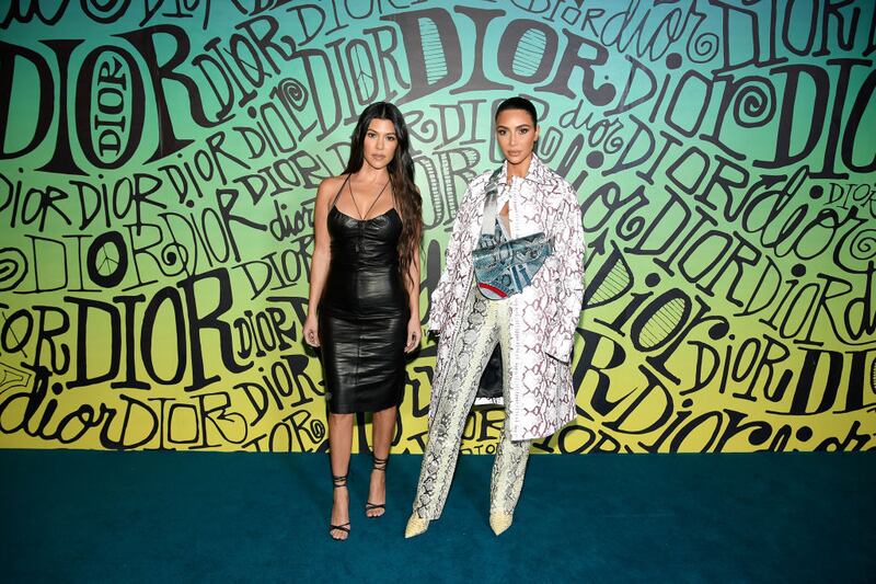 MIAMI, FLORIDA - DECEMBER 03: Kourtney Kardashian and Kim Kardashian West attend the Dior Men's Fall 2020 Runway Show on December 03, 2019 in Miami, Florida. (Photo by Dimitrios Kambouris/Getty Images for Dior Men)