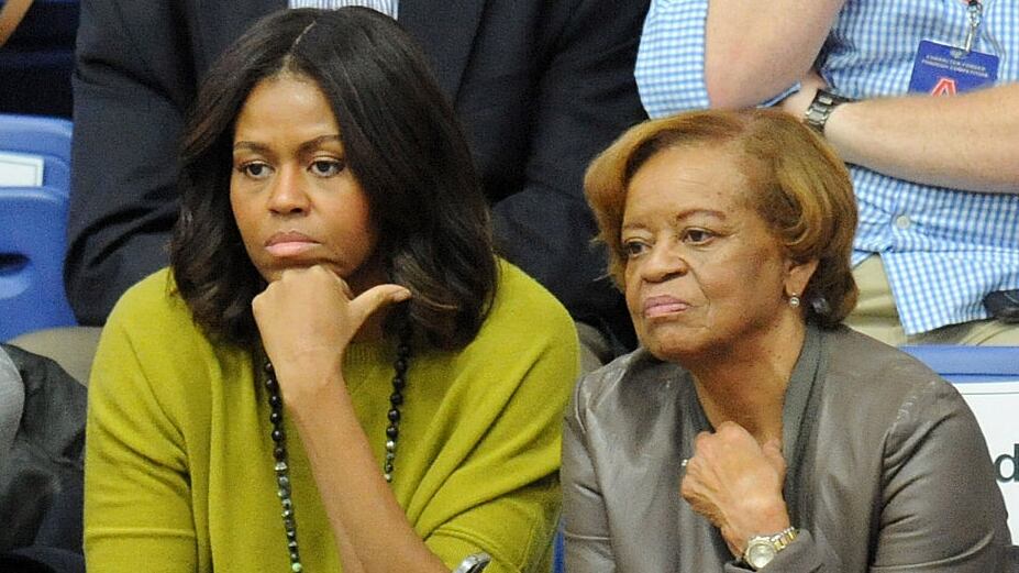 WASHINGTON, DC - NOVEMBER 23: First lady Michelle Obama (L) and Marian Robinson watch a women's college basketball game between the Princeton Tigers and the American University Eagles at Bender Arena on November 23, 2014 in Washington, DC. President Barack Obama's niece, Leslie Robinson, was playing for Princeton. (Photo by Mitchell Layton/Getty Images)