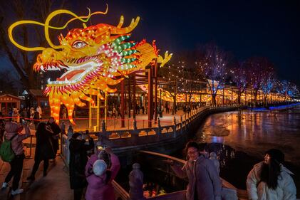 BEIJING, CHINA - FEBRUARY 9: People gather around a large dragon figure for the Chinese New Year and Spring Festival at a park in a local historic area on February 9, 2024 in Beijing, China. China will usher in the Year of the Dragon on the Lunar New Year which begins on February 10th. (Photo by Kevin Frayer/Getty Images)