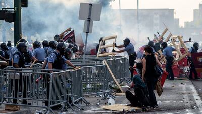 Police remove barricades set by protesters during a demonstration over the killing of George Floyd by a policeman outside the Third Police Precinct on May 27, 2020, in Minneapolis, Minnesota.